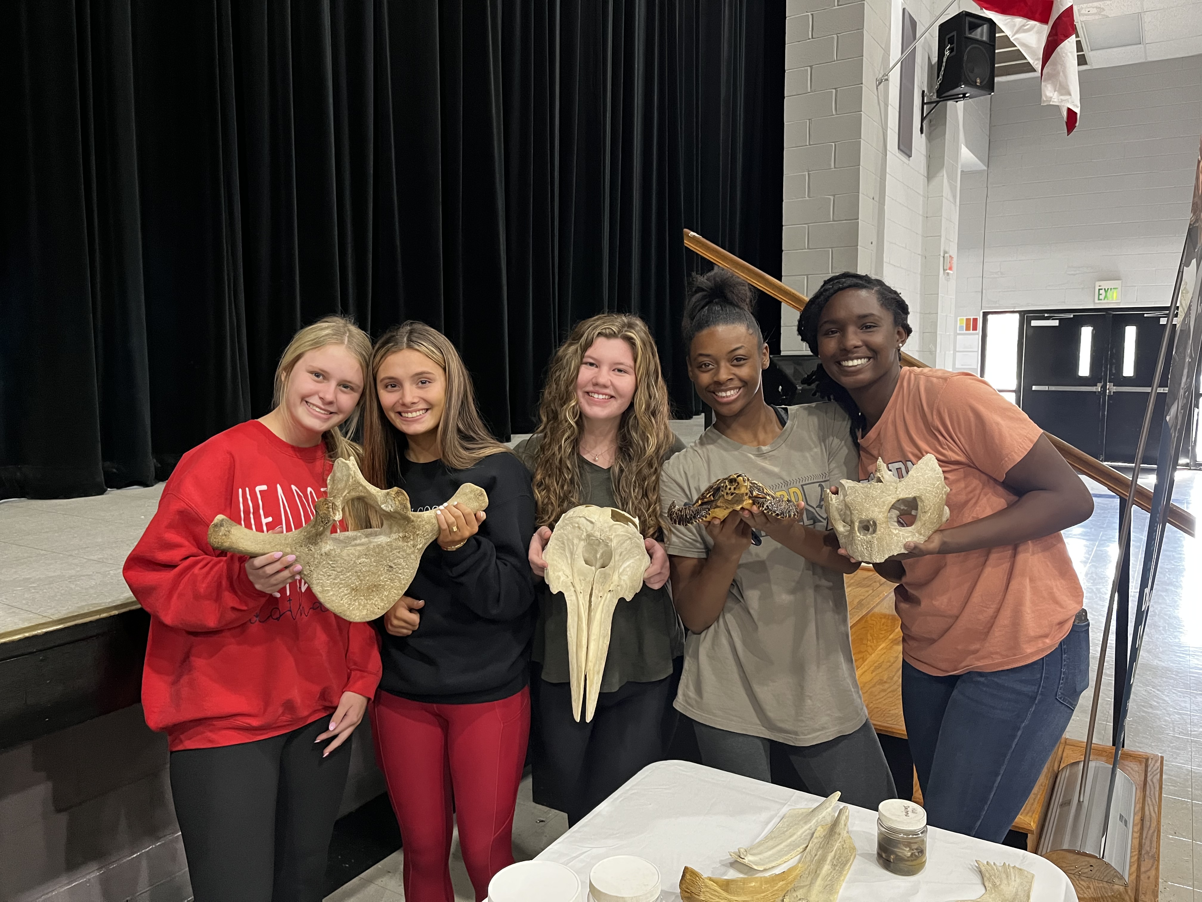 High School students hold specimens from BayMobile visit