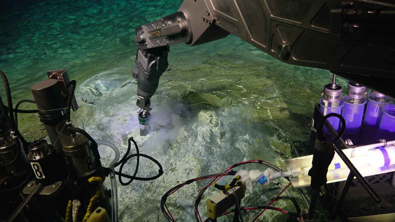 Remotely operated arm collects samples from seafloor.