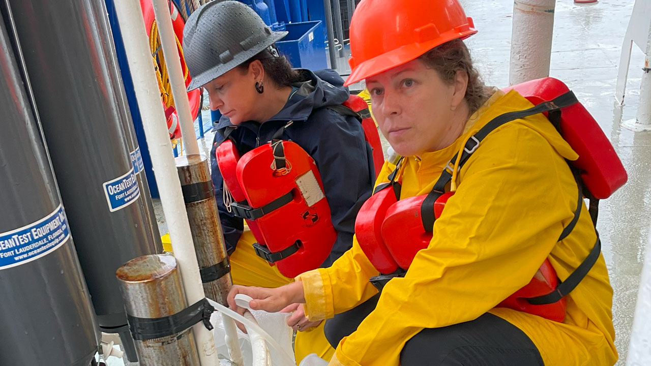 Brandi Kiel Reese collecting a water sample. 