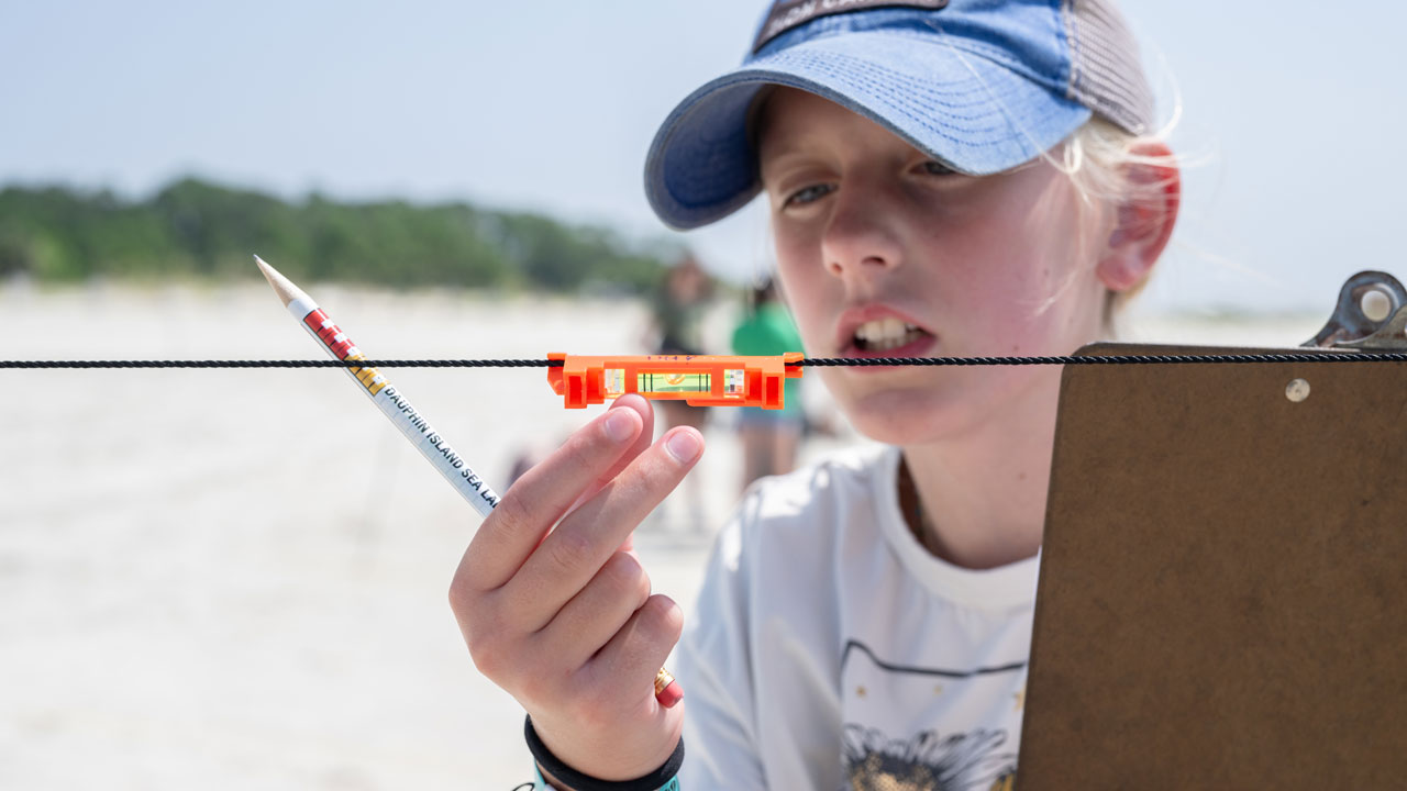 student uses a level when studying sea level rise